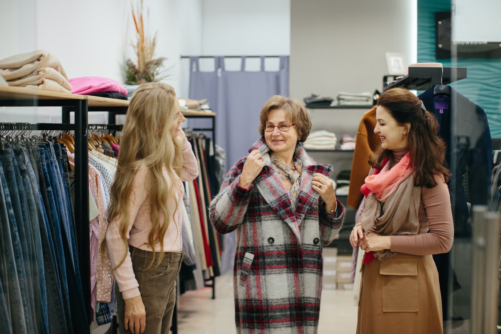 older-woman-trying-on-clothes-in-the-dressing-room-of-a-clothing-store.jpg